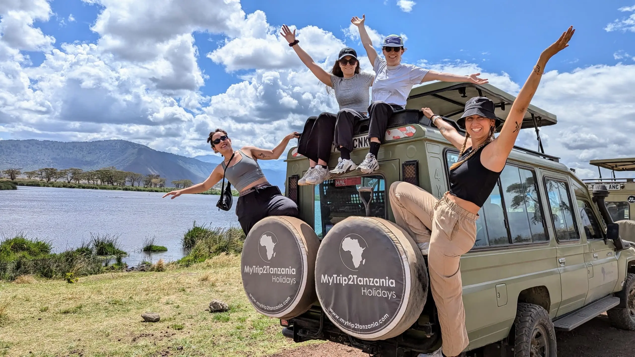 Group Safari Photo Moment .webp Guests taking a photo together during a shared group safari